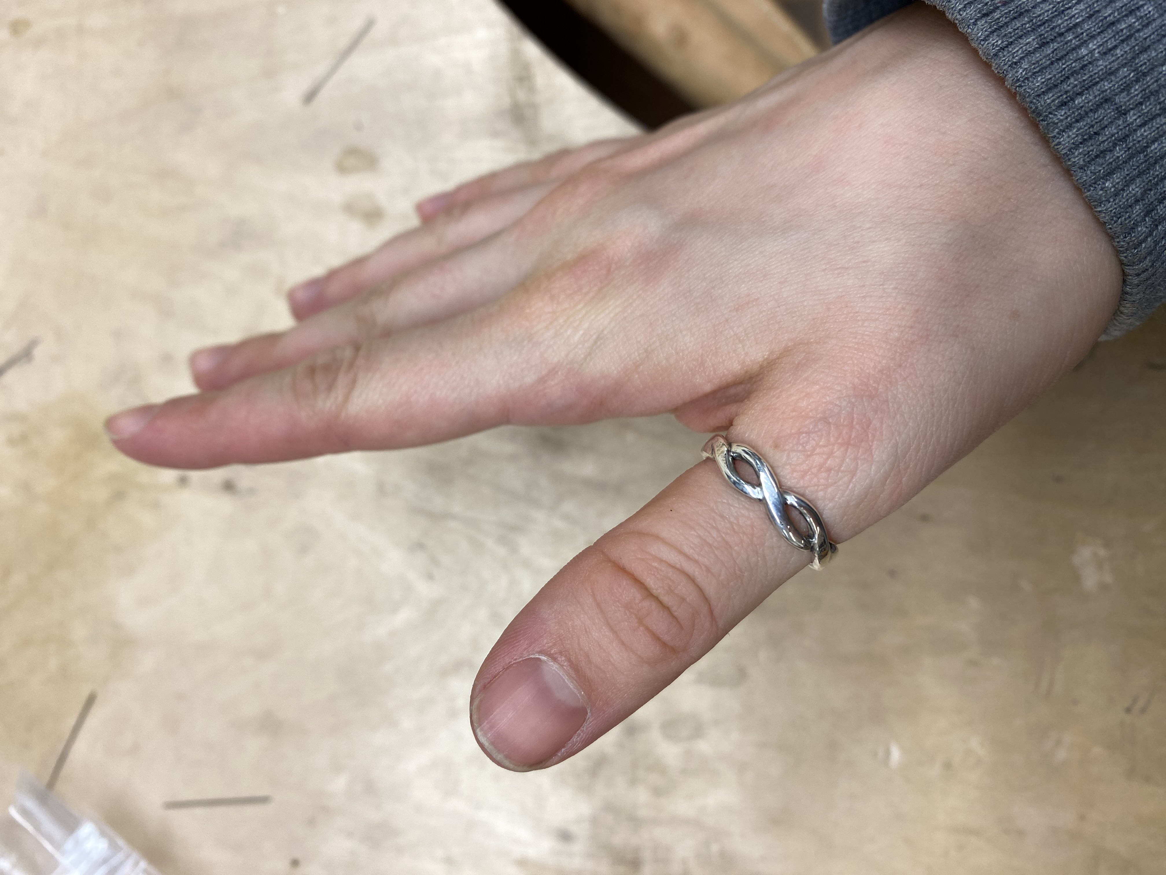 a ring where two wires intertwine to make it look like an infinity sign